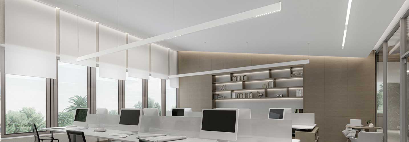 Workspace featuring computer stations with 3Gi suspended along the pod, integrating LINIA diffused and Zoie low-glare inserts.